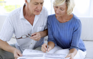 A senior couple reviewing their finances